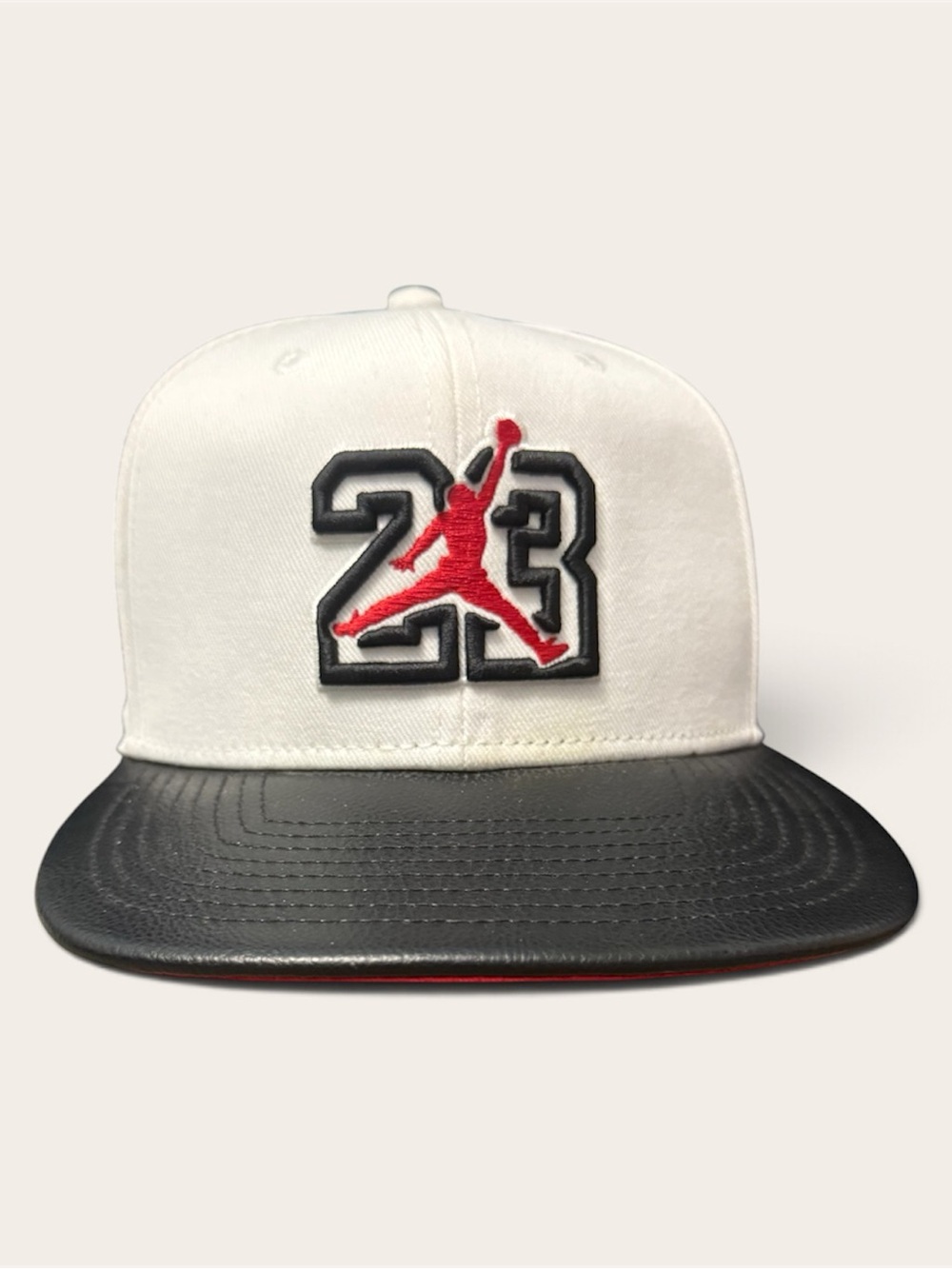White and Black Snapback Hat with Red Jumpman 23 Patch